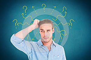 Digital composite image of confused man with arrows and question marks