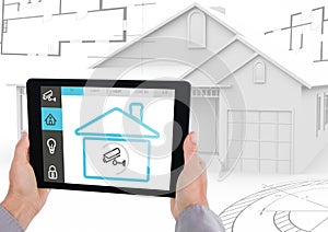 Digital composite image of hand holding a digital tablet with house security concept