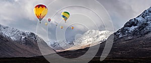 Digital composite image of hot air balloons flying over Majestic beautiful Winter landscape image of Lost Valley in Scotland