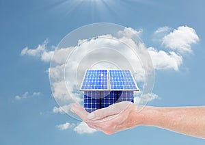 Digital composite image of solar panel house on hand against sky