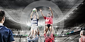 Digital composite image of team of rugby players jumping to catch the ball in a line out in sports s