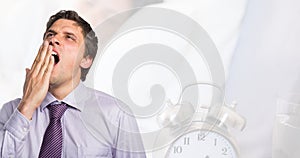 Digital composite image of tired caucasian young businessman with alarm clock, copy space