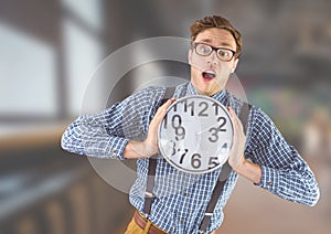 man holding clock in front of blurred background