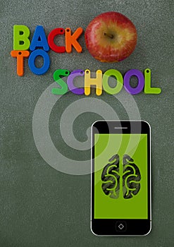 Phone on a school table with brain icon on screen