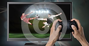 Playing soccer computer game with controller in hands