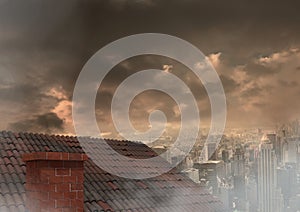 Roof with chimney and city under clouds