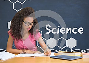 Student girl at table reading against blue blackboard with science text and graphics