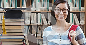 Student woman in education library with graduation hat and books