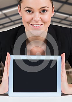 Woman holding tablet with warehousse background