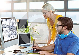 young man and woman working on the computer on the new office design ( white and dark blue)