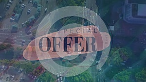 Digital composition of special offer text banner against aerial view of city traffic
