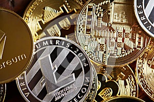 Digital cryptocurrencys Bitcoin, Ethereum, Litecoin on wooden background. Cryptocurrency concept, close-up