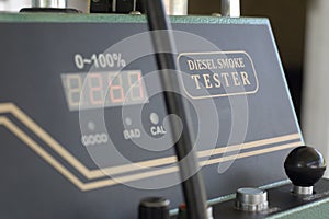 Digital diesel smoke tester at vehicle inspection station.