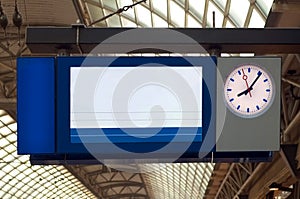 Digital display at train station platform with clock