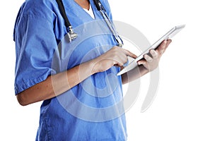 Digital doctoring. Cropped studio shot of a doctor using a digital tablet against a white background.