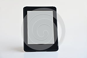 Digital e-book reader with white blank screen stand on the white background