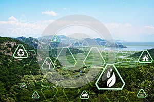 Digital eco icons and mountains on sunny day