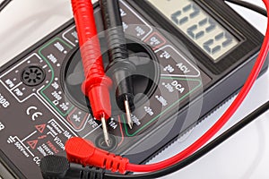 Digital electrical tester multimeter in black case isolated on white background. Digital multimeters have a numeric display, can