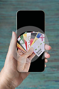 Digital fidelity cards. Hand holding mobile phone