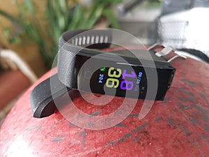 Digital fitness waistband watch on display.