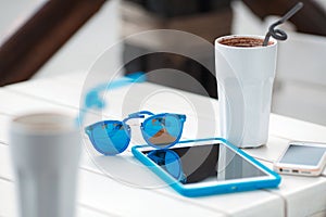 Digital gadget blue glasses and hot coffee