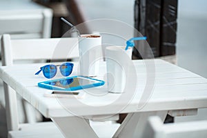 Digital gadget blue glasses and hot coffee