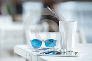 Digital gadget blue glasses and hot coffee