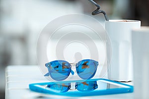 Digital gadget blue glasses and hot coffee