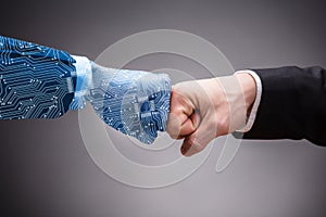 Digital Generated Human Hand And Businessman Making Fist Bump