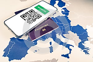 Digital green passport with QR code on a smartphone over an EU map