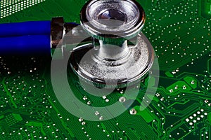 Digital health patient data storage concept - Isolated blue stethoscope on green computer circuit board