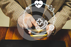 A digital healthcare concept image showing a person using a smartphone for teleconsultation, with medical icons representing photo