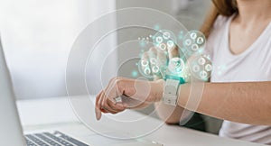 Digital and Healthcare trends, Woman using smartwatch to track health, digital health concept, with holograms of healthy food,