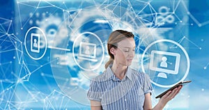Digital icons over woman using digital tablet against network of connections on blue background