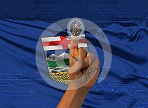 Digital ID Alberta on finger of dark skin person and Canadian province flag on background