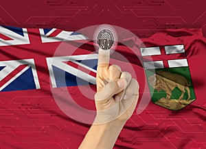 Digital ID Manitoba, finger of white skin person and Canadian province flag on background