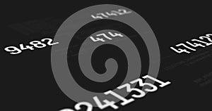 Digital image of multiple changing numbers over data processing against black background