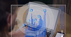 Digital interface with statistical data processing against mid section of person using laptop