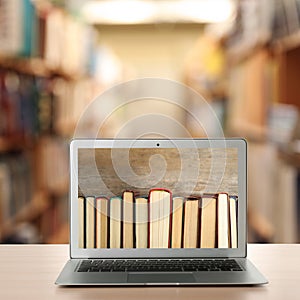 Digital library concept. Modern laptop on table