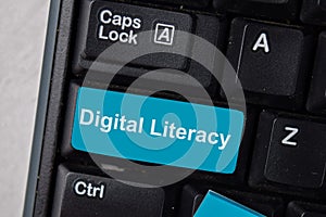 Digital Literacy write on keyboard isolated on laptop background photo