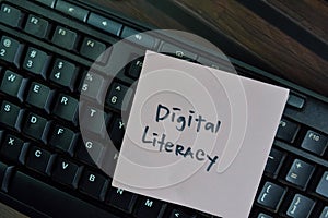 Digital Literacy write on sticky notes isolated on Wooden Table