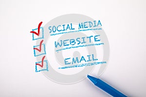 Digital Marketing concept. Social Media, Website and Email. Checklist on a sheet of white paper
