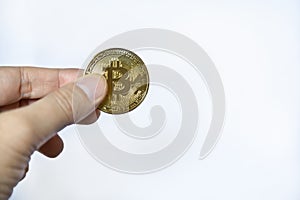 Digital Money and Cryptocurrency Concept. Closeup of gold bitcoin coin on mand hand on white background with copy sapce photo
