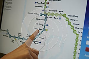 Digital monitor of public transport subway map with finger