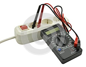 Digital multimeter and electric outlet isolated on white