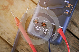 Digital multimeter and wiring on wooden table. special tools of technician for work with circuit and electrical.