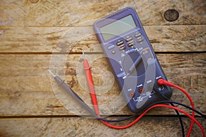 Digital multimeter and wiring on wooden table. special tools of technician for work with circuit and electrical.