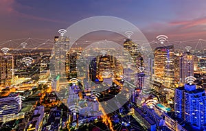 Digital network connection lines and wifi or wireless icons with Bangkok Downtown, Thailand. Financial district in smart city in