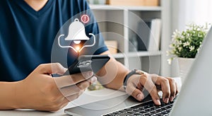 Digital Notification Alert on Smartphone While Multitasking on Laptop
