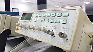 Digital oscilloscope in the foreground in the background